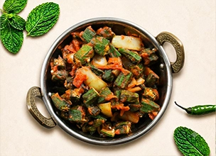 Bhindi masala stir-fried with onions and tomatoes is served at a North Indian restaurant.